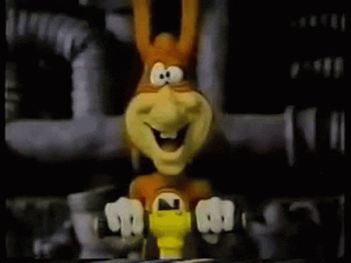 A Cartoon Rabbit Is Sitting On A Table With A Yellow Object In Front Of It . GIF