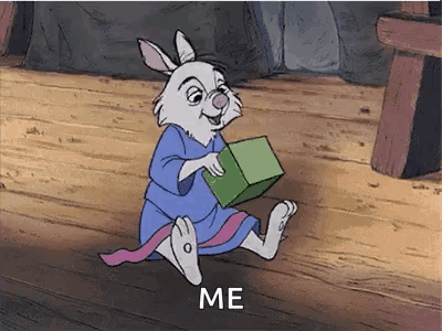 A Cartoon Rabbit Is Sitting On A Wooden Floor Holding A Green Box And Says `` Me '' . GIF