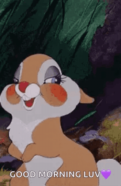 A Cartoon Rabbit Is Standing In The Woods And Smiling . GIF