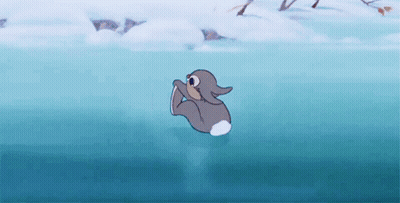 A Cartoon Rabbit Is Swimming In A Lake . GIF