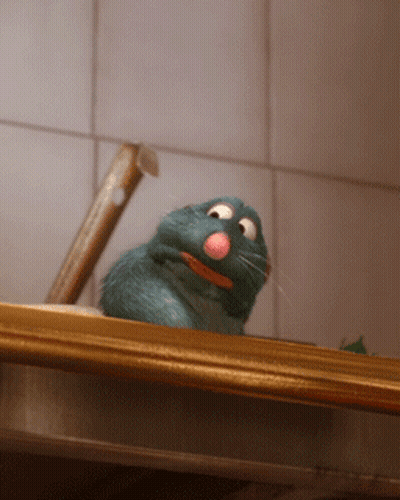 A Cartoon Rat With A Pink Nose Is Sitting On A Counter GIF