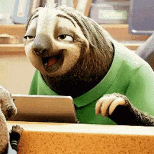 A Cartoon Sloth Wearing A Green Shirt Is Sitting At A Table With A Tablet . GIF