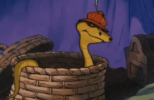 A Cartoon Snake Wearing A Red Hat Is Sitting In A Basket GIF
