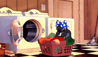 A Cartoon Stitch Is Sitting In A Laundry Basket GIF