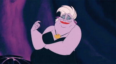A Cartoon Ursula From The Little Mermaid Is Smiling And Making A Face . GIF