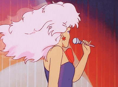 A Cartoon Woman Singing Into A Microphone With Pink Hair GIF