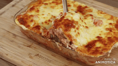 A Casserole Dish With A Spoon In It Is Made By Maxwell Williams GIF