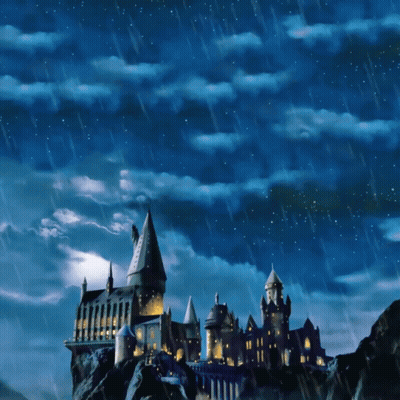 A Castle On Top Of A Hill With A Blue Sky And Rain GIF
