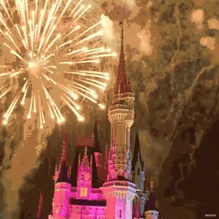 A Castle With Fireworks In The Background And Disney Written On The Bottom GIF