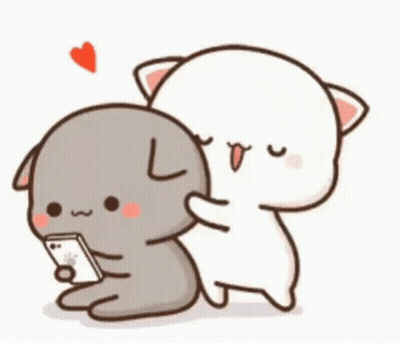 A Cat And A Dog Are Hugging Each Other While The Cat Is Looking At A Cell Phone . GIF