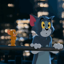 A Cat And A Mouse Are Standing Next To Each Other On A Railing GIF