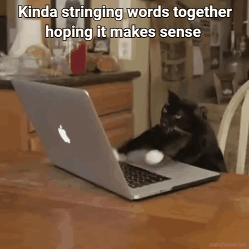A Cat Is Playing With An Apple Laptop On A Table GIF
