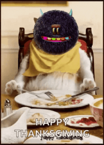 A Cat Is Sitting At A Table With A Plate Of Food And A Happy Thanksgiving Greeting GIF
