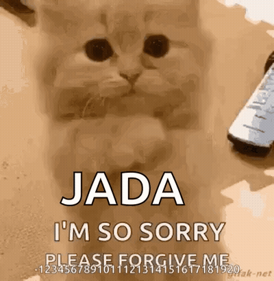 A Cat Is Sitting Next To A Remote Control And Saying Jada I 'M So Sorry . GIF