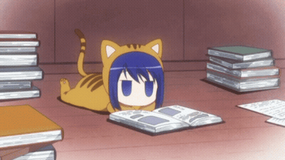 A Cat Laying On The Floor Reading A Book Next To A Pile Of Books GIF