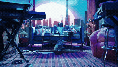 A Cat Sits On The Floor In Front Of A Keyboard GIF