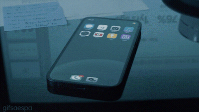 A Cell Phone Laying On A Glass Table With A Gifsaespa Watermark At The Bottom GIF