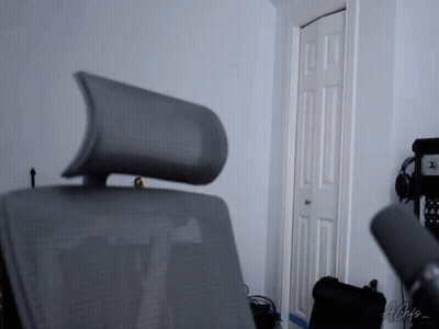 A Chair With A Headrest Is In A Room With A Microphone And A Sign That Says Agis GIF