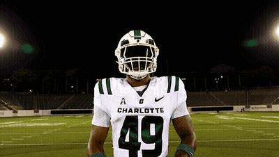 A Charlotte Football Player Wearing Number 49 Poses For A Photo GIF