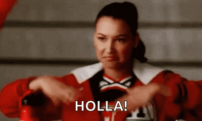 A Cheerleader Is Holding A Fire Extinguisher And Making A Face . GIF
