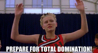 A Cheerleader Is Holding Her Arms Up In The Air And Says `` Prepare For Total Domination ! '' GIF