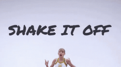 A Cheerleader Is Jumping In The Air With The Words Shake It Off In The Background GIF