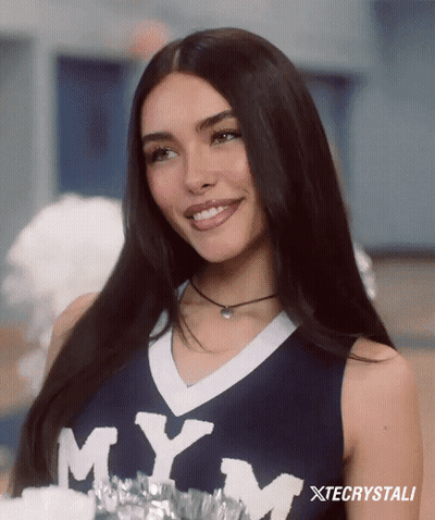 A Cheerleader Wearing A Mym Jersey Smiles For The Camera GIF