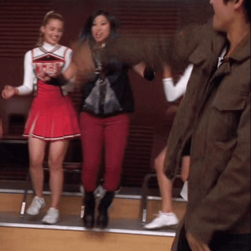 A Cheerleader Wearing A Red Skirt Has The Word Angels On Her Shirt GIF