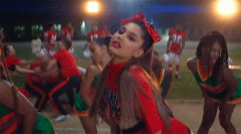 A Cheerleader Wearing A Red Uniform With The Word Unc On The Front GIF