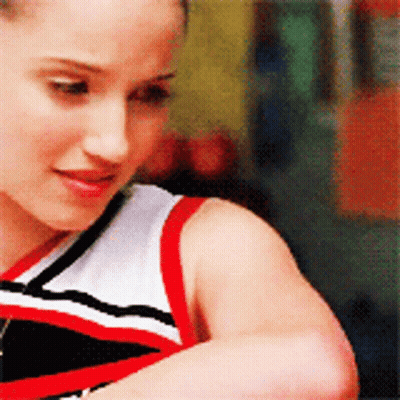 A Cheerleader Wearing A Red White And Black Outfit GIF