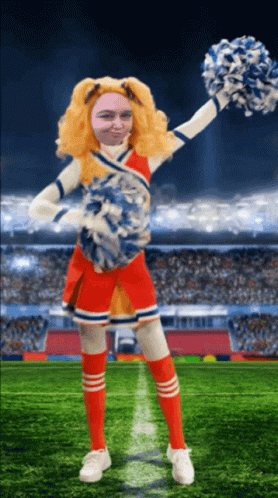 A Cheerleader With A Man 'S Face On Her Face Is Holding Pom Poms GIF