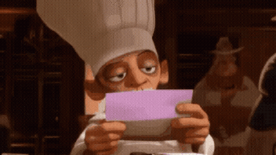 A Chef In A Chef 'S Hat Is Holding A Piece Of Paper In Front Of His Face . GIF