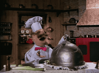 A Chef In A Kitchen With A Helmet On Top Of The Table GIF