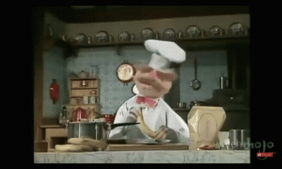 A Chef Is Holding A Banana In His Hand In A Kitchen GIF