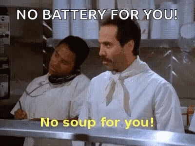 A Chef Is Talking On A Phone In A Kitchen While Another Chef Looks On . GIF