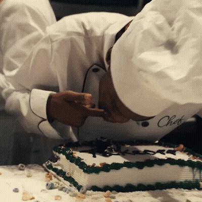 A Chef Wearing A White Hat With The Word Chef Written On It GIF