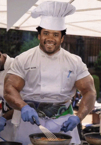 A Chef Wearing A White Shirt That Says Chef Rusk GIF