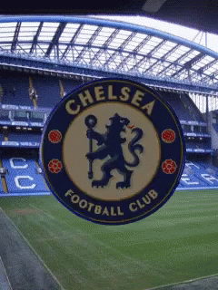 A Chelsea Football Club Logo Is Displayed In Front Of A Soccer Field GIF