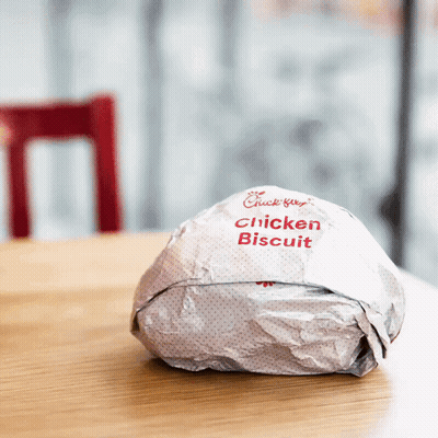 A Chick-Fil-A Chicken Biscuit Is Wrapped In Paper GIF