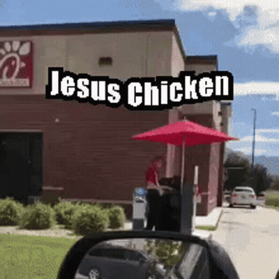 A Chick Fil A Restaurant With Jesus Chicken Written On The Side Of It GIF