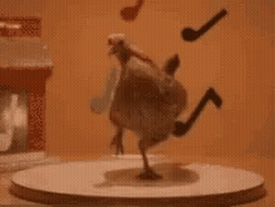 A Chicken Is Standing On Its Hind Legs On A Round Table With A Pipe Hanging From Its Tail . GIF