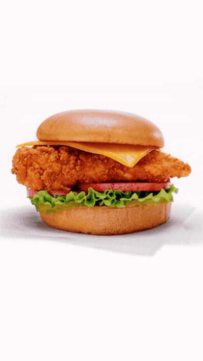 A Chicken Sandwich With Lettuce Tomato And Cheese GIF