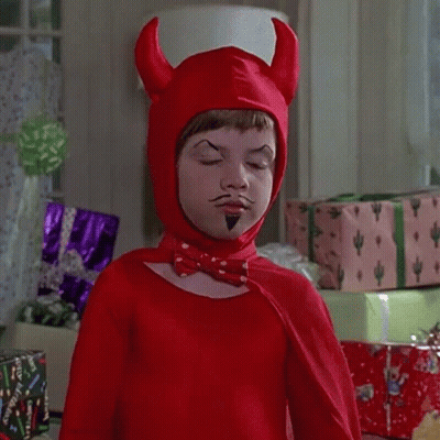 A Child Dressed In A Red Devil Costume With Horns And A Mustache GIF