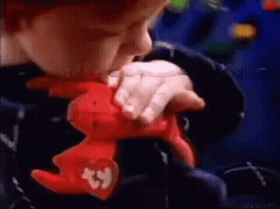 A Child Is Holding A Stuffed Animal With A Beanie On It . GIF