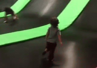 A Child Is Riding A Skateboard On A Trampoline In A Park . GIF