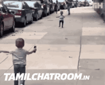 A Child Is Running Down A Sidewalk With The Words Tamilchatroom.in Written On The Bottom GIF