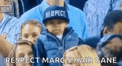 A Child Wearing A Hat That Says Respect Is Sitting In A Crowd Of People . GIF