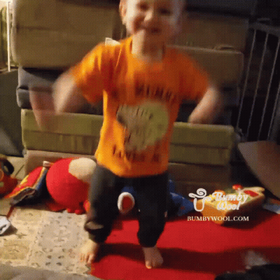A Child Wearing An Orange Shirt That Says Winnie The Pooh On It GIF