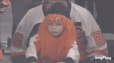 A Child Wearing An Orange Wig And A Jersey With The Number 8 GIF