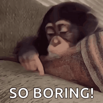 A Chimpanzee Is Laying On A Bed With Its Eyes Closed And Pointing At Something . GIF